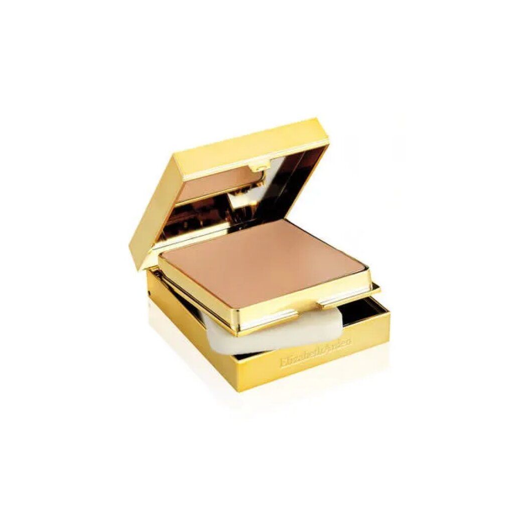 Geöffnete, goldfarbene Kompakt-Make-up-Dose. Beige Creme-Make-up und Schwamm sichtbar. Goldfarbener Rahmen.