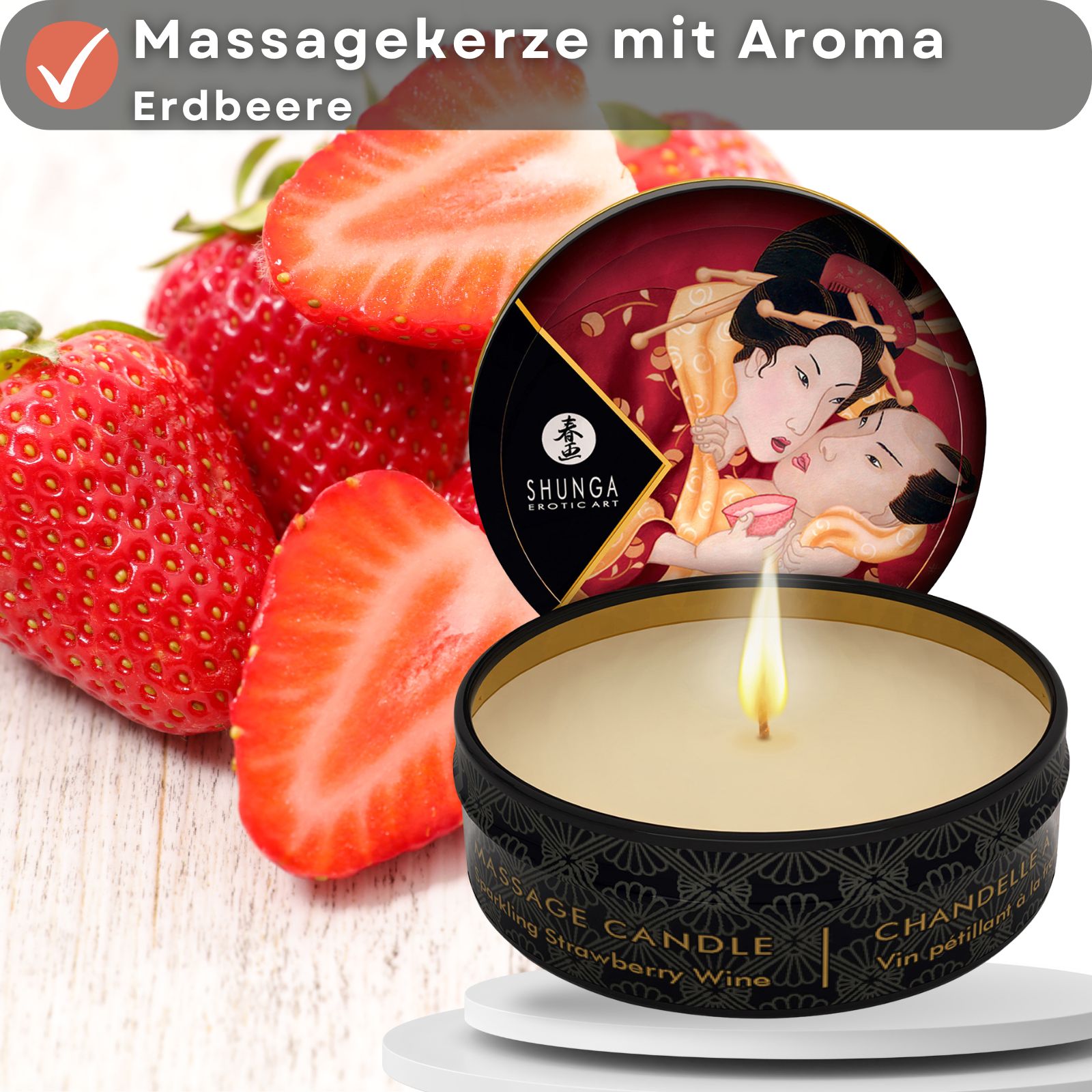Massagekerze mit Erdbeeraroma neben Erdbeeren. Dose mit Deckel, Motiv: erotische Kunst. Text: Massage Candle, Strawberry Wine.