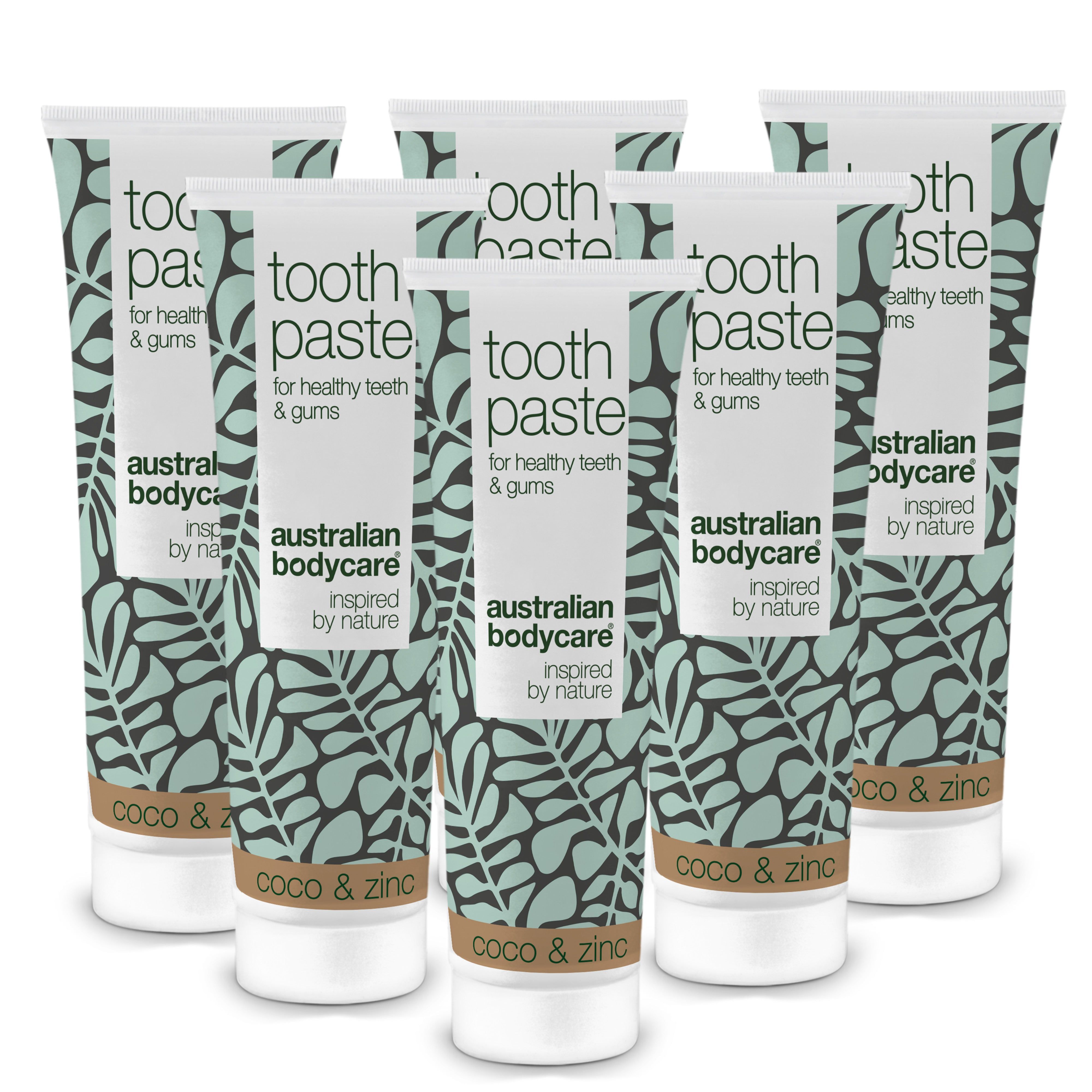 Mehrere Tuben Zahnpasta, weiß mit grünen Blättern. Aufschrift: Toothpaste, Australian Bodycare, Coco & Zinc.