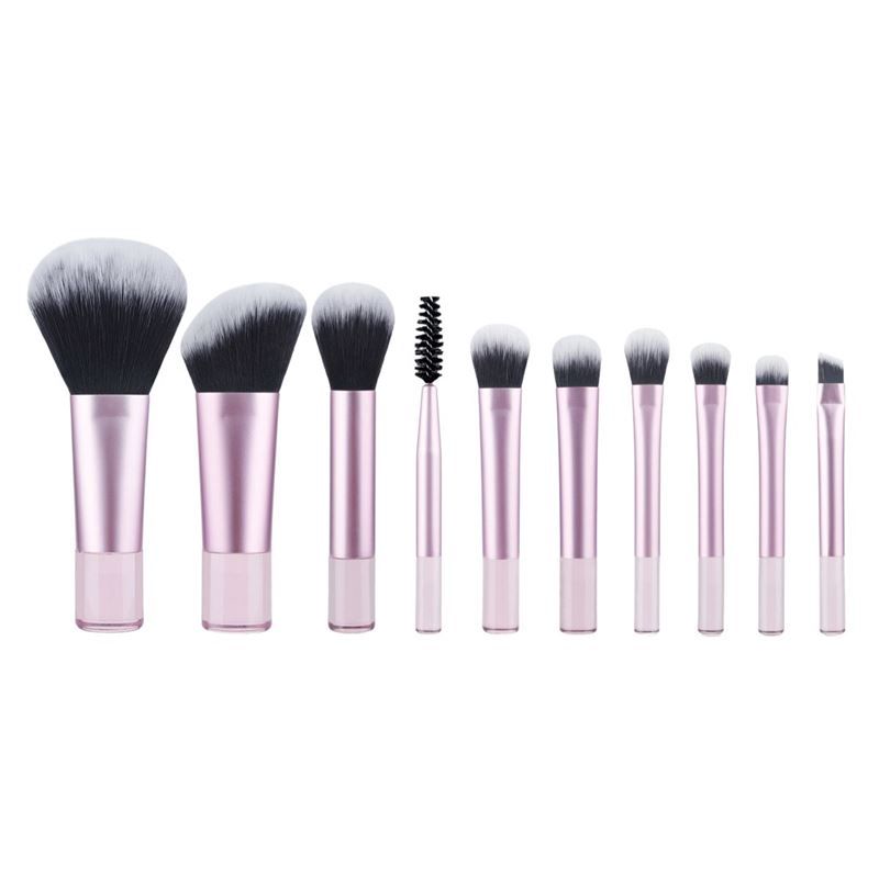 Pinsel-Set mit rosa Griffen und schwarzen und weißen Borsten. Verschiedene Pinselformen. Aufgereiht auf einer Oberfläche.