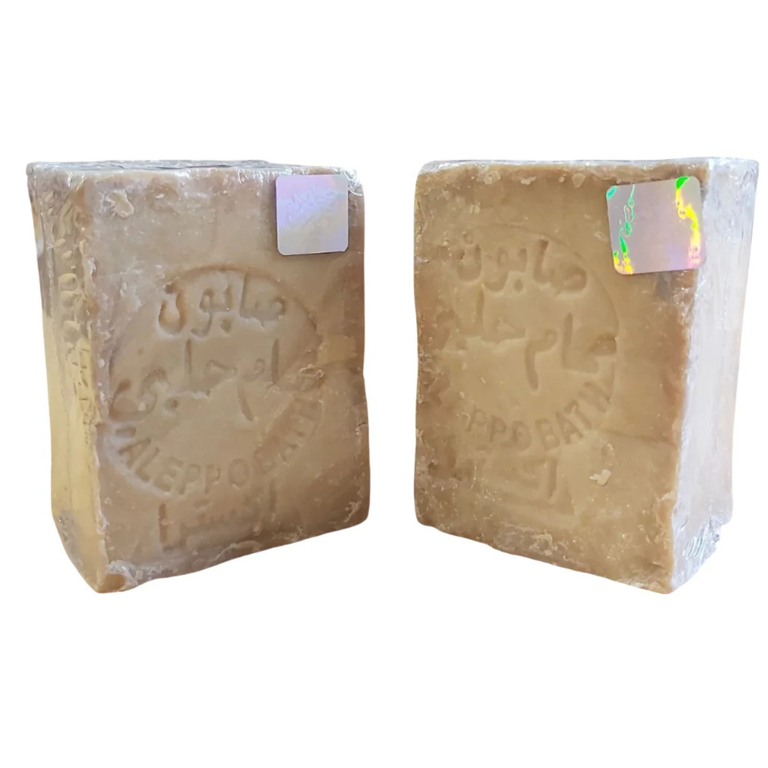 Zwei Seifenstücke, rechteckig, in Folie verpackt. Geprägt: arabische Schriftzeichen, "Aleppo Bath". Mit Hologramm-Aufklebern.
