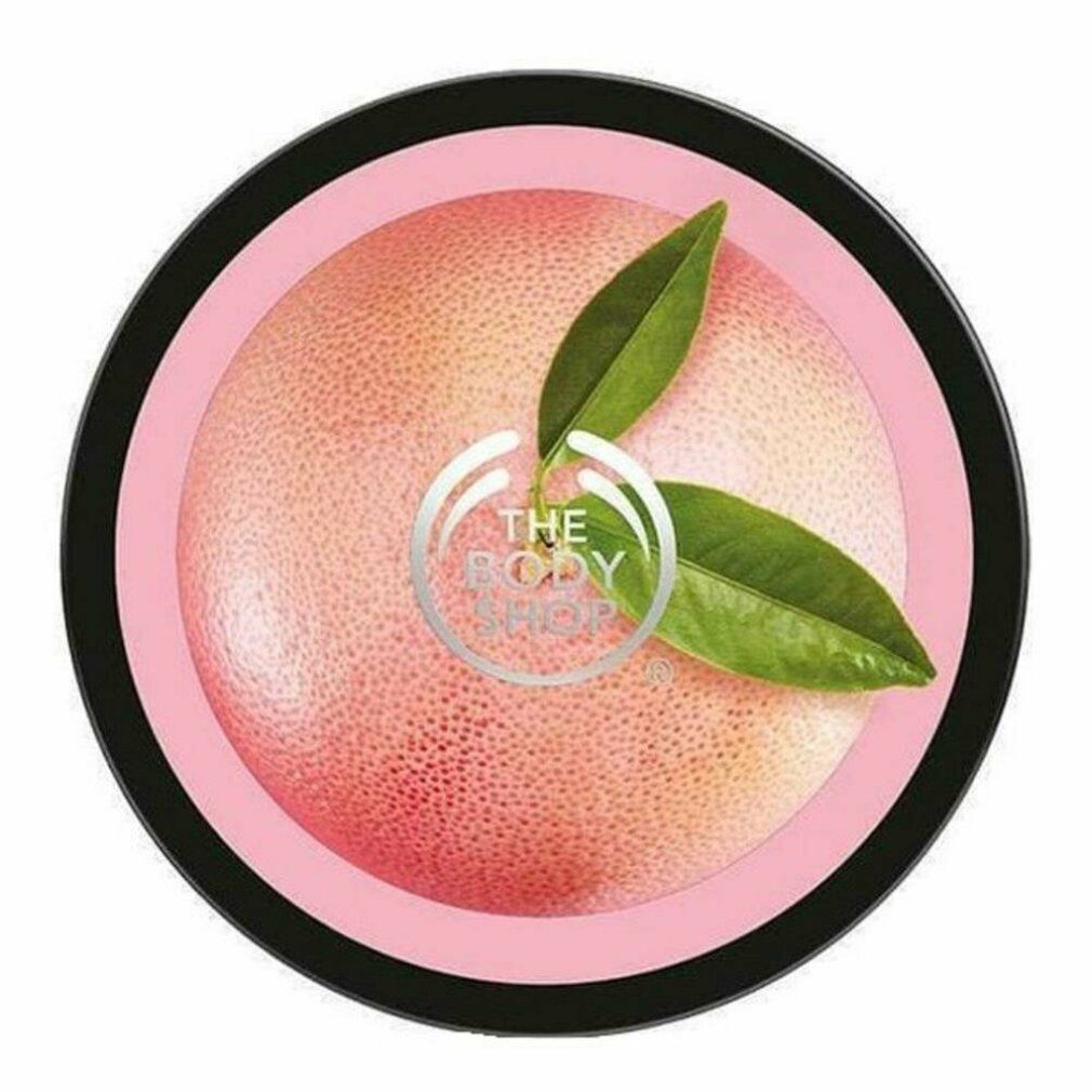 Runder Tiegel mit rosa Inhalt, Grapefruit-Motiv und Blättern. Logo: The Body Shop.