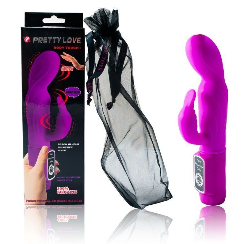 Lila Vibrator mit Verpackung und Aufbewahrungsbeutel. Verpackung mit Produktname und Handabbildung. Beutel aus schwarzem Netzstoff.