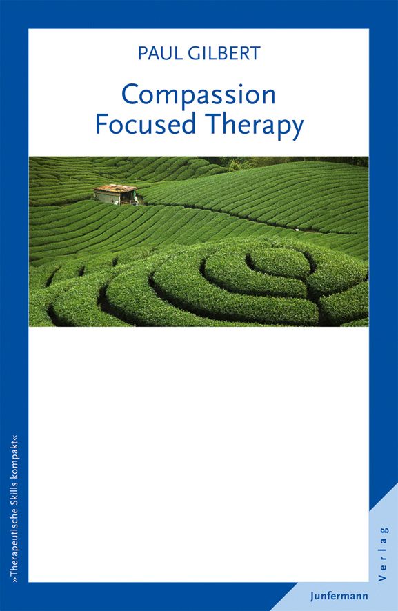 Buchcover mit Titel 'Compassion Focused Therapy' von Paul Gilbert. Landschaftsfoto mit grünen Hügeln. Verlag Junfermann.