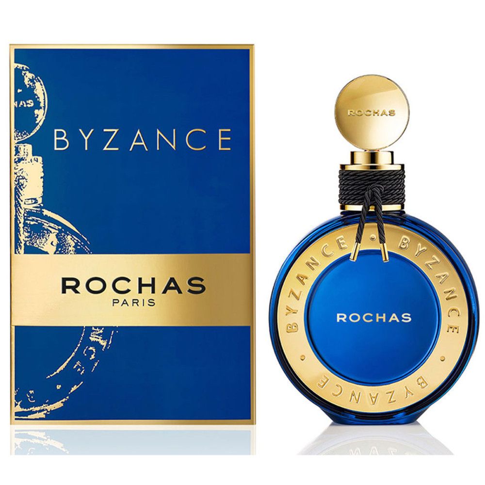 Blau-goldene Parfumflasche und -verpackung. Aufschrift: BYZANCE, ROCHAS PARIS. Runde Flasche mit goldenem Deckel und schwarzem Band.