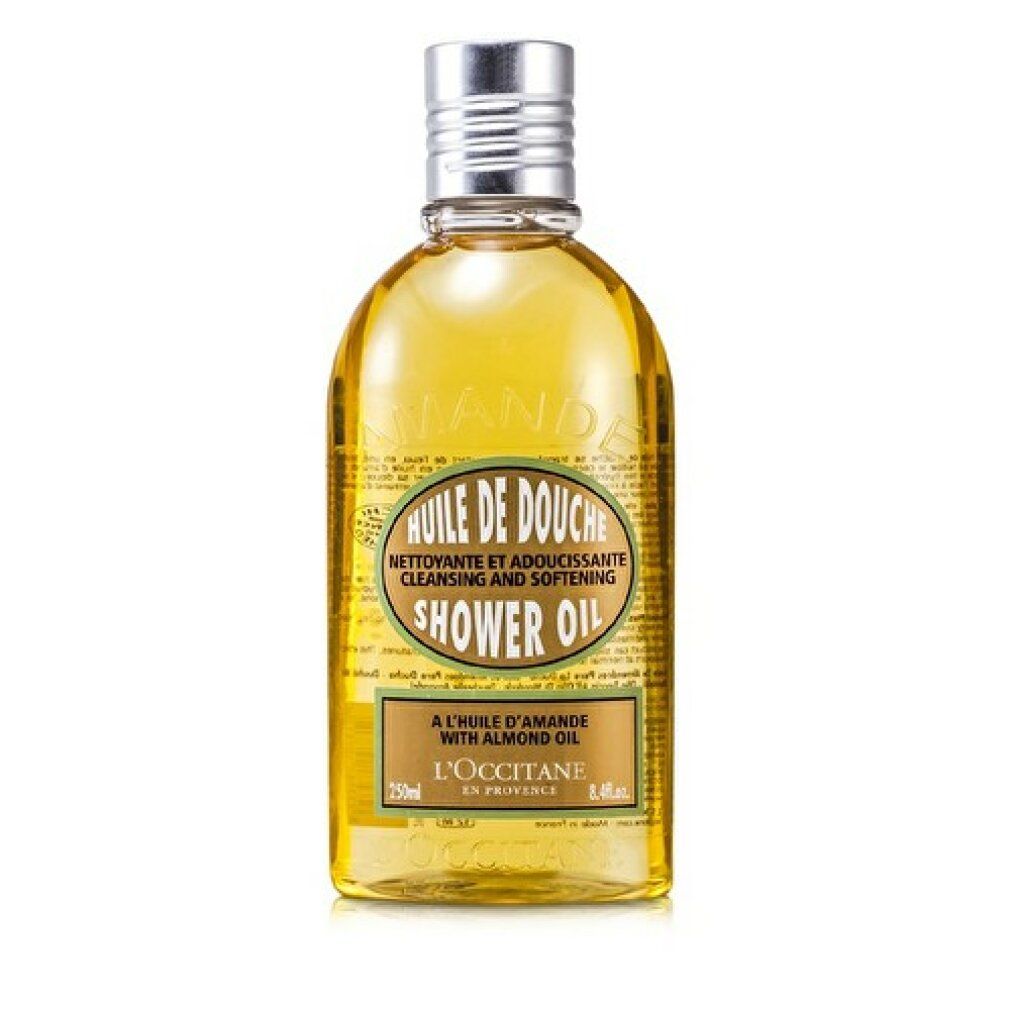 L'Occitane Mandel Duschöl Flasche. Gelbe Flüssigkeit, silberner Deckel. Aufschrift: Huile de Douche, Shower Oil.