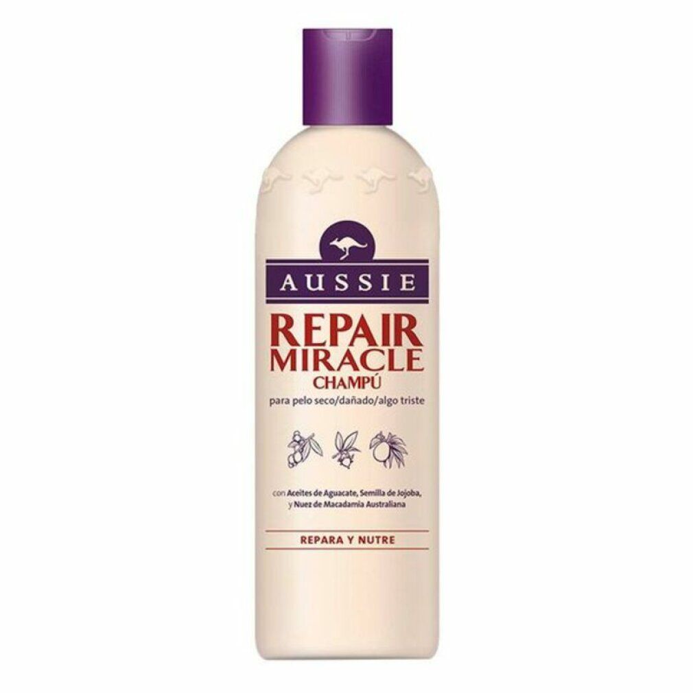 Beige Shampoo-Flasche mit lila Deckel. Aufschrift: Aussie Repair Miracle Champú. Mit Känguru-Logo.