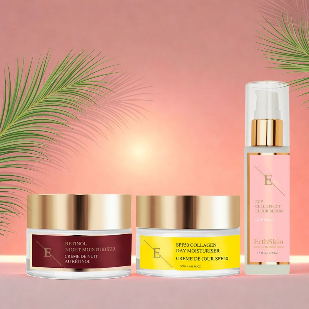 Drei Kosmetikprodukte: Tagescreme, Nachtcreme und Serum. Cremetiegel mit goldenen Deckeln, Serumflasche mit Sprühkopf. Beschriftung auf Englisch und Französisch.