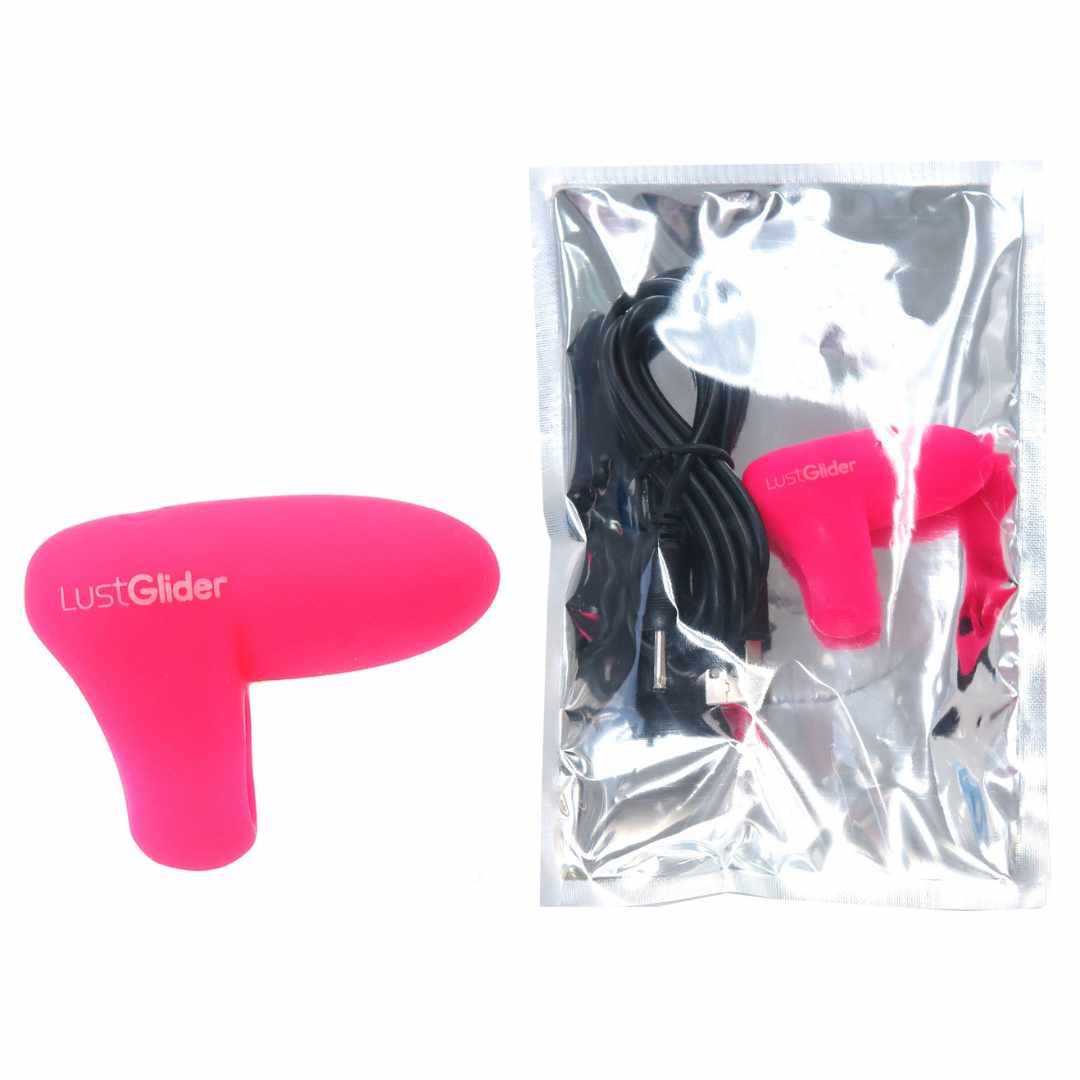 Rosa Finger-Vibrator und Zubehör in transparenter Verpackung. Enthält Ladekabel.