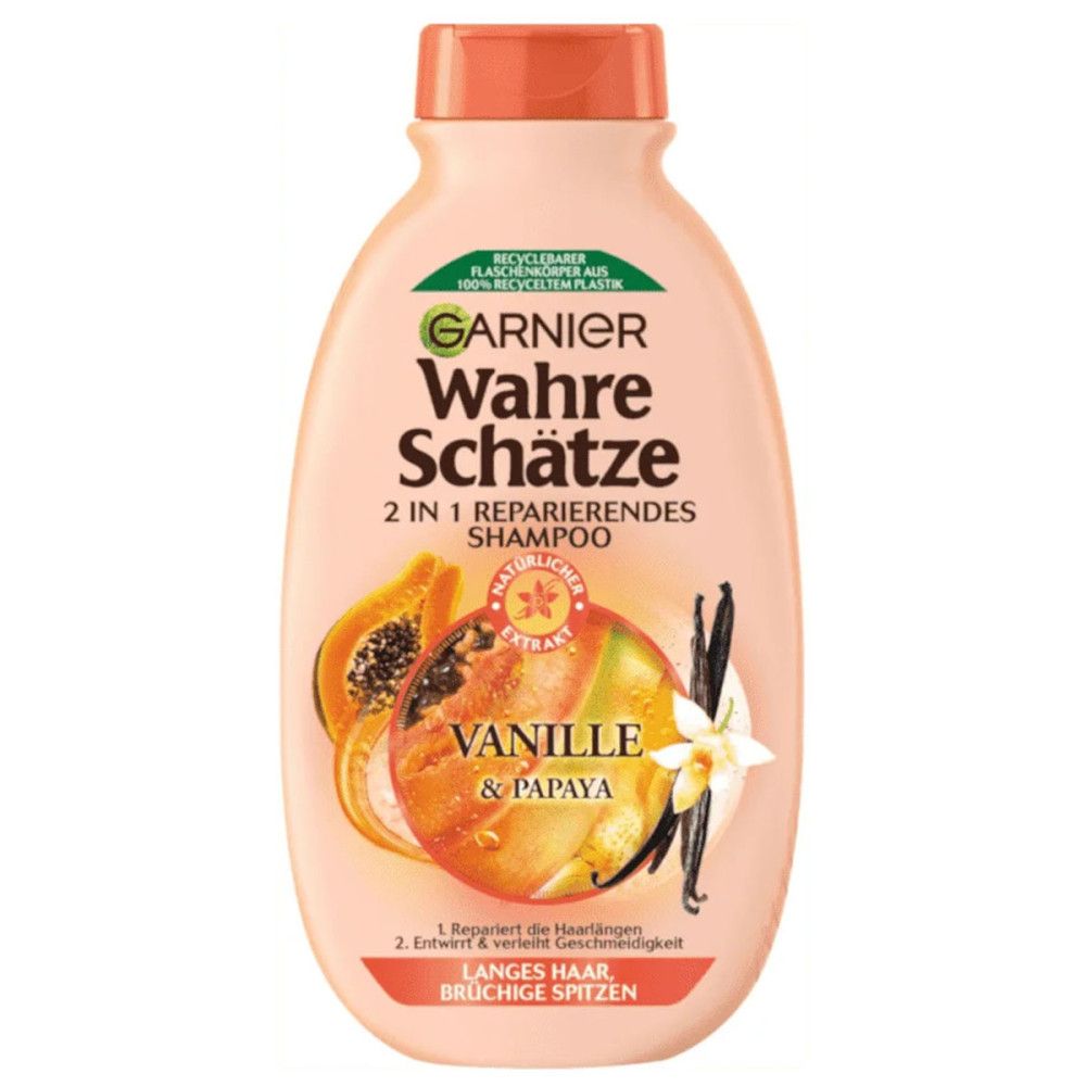 Flasche Shampoo. Marke Garnier Wahre Schätze. 2 in 1 Reparatur-Shampoo Vanille & Papaya. Für langes Haar, brüchige Spitzen. Mit Papaya- und Vanille-Abbildung.