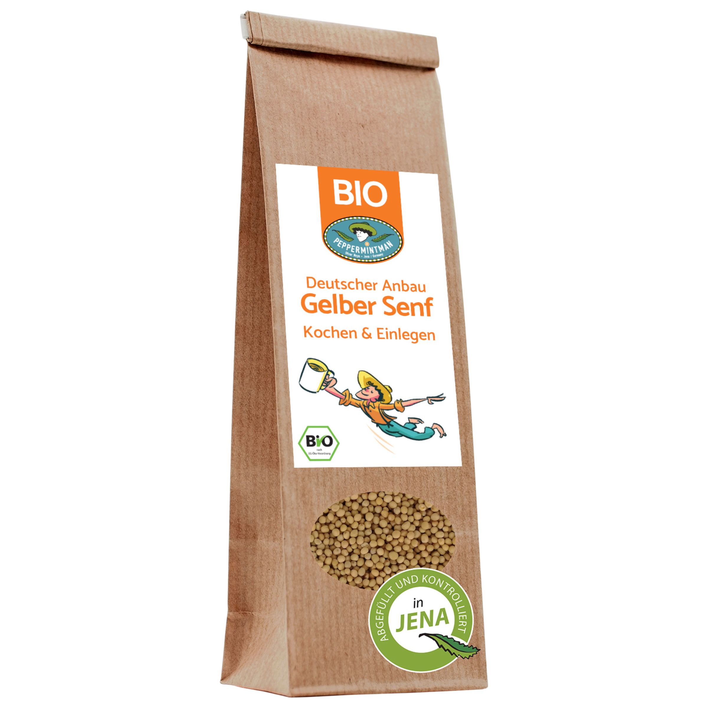 Braune Papiertüte mit Etikett. Aufschrift: Deutscher Anbau Gelber Senf, Bio. Sichtfenster mit Senfkörnern. Bio-Siegel.