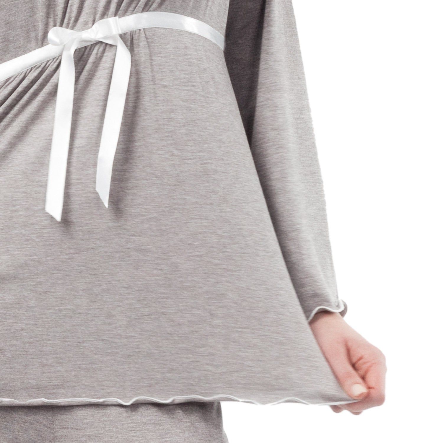 Nahaufnahme des grauen Schwangerschaftspyjama-Oberteils. Weißes Bindeband, lange Ärmel. Wellenform am Saum.